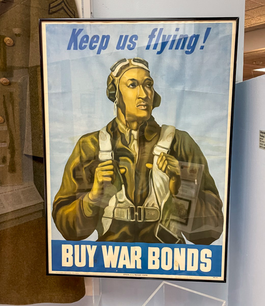 Old poster that reads "Keep us flying! Buy war bonds".