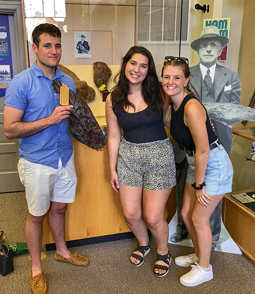 Visitors pose with the world’s oldest ham at the Isle of Wight County Museum in Smithfield. | Photo courtesy of the Isle of Wight County Museum