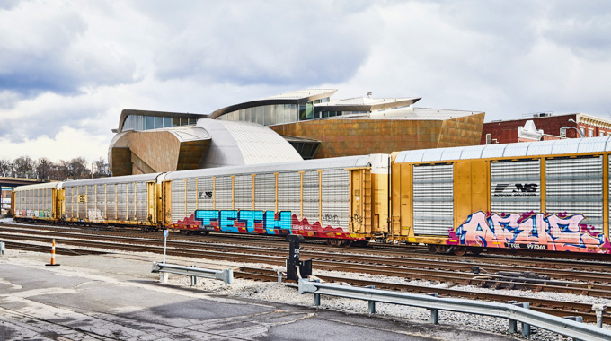 Taubman Museum of Art exterior with rail cars in front.