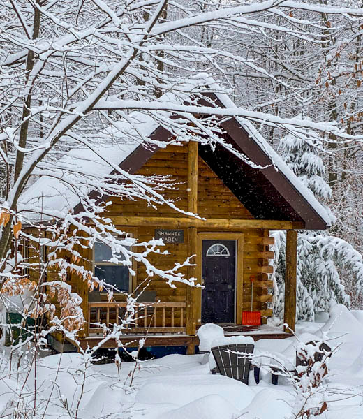 Mountain Creek Cabin surrounded by thick piles of snow