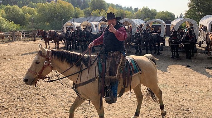 Covered wagons carrying tour-goers ready to roll out. 