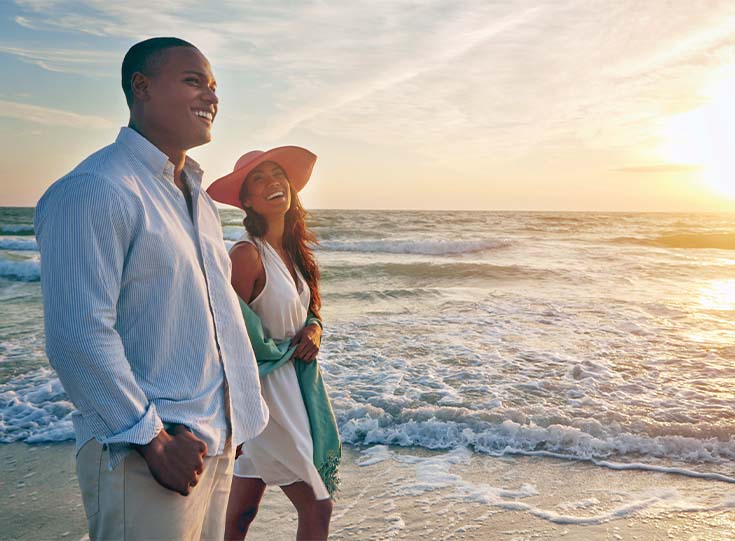 Couple enjoying a sunset stroll Couple enjoying a sunset stroll