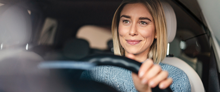 1193069476-Smiling-young-woman-driving Smiling young woman driving