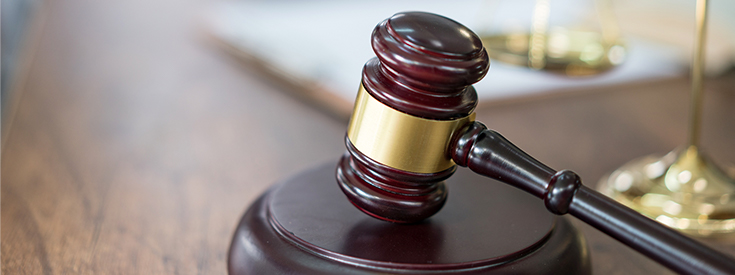 1074051648-justice-scales-and-books-and-wooden-gavel Justice scales and books and wooden gavel