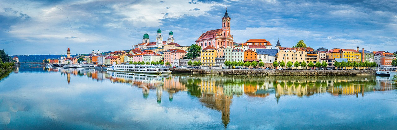 Panoramic view of the historic city of Passau reflecting in famous Danube river in beautiful evening light at sunset, Bavaria, Germany
