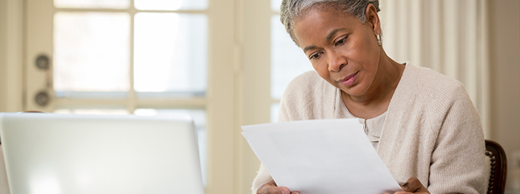 Woman reviewing her policy paperwork Woman reviewing her policy paperwork