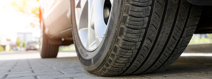 A used tire with some road wear. A used tire with some road wear.
