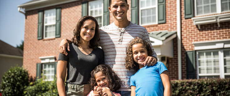 Family standing in front of home Family standing in front of home