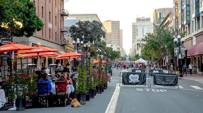 Potted plants and umbrellas provide shade and privacy for diners in San Diego's Gaslamp Quarter. | Photo by Javier Luna @ ANONM Studios