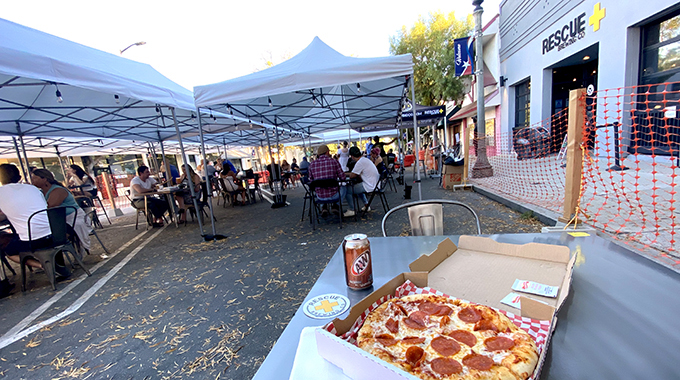 Pepperoni pizza from Paulie's Pizza Pub is just as tasty outdoors as indoors. | Photo by Eric Van Eyke
