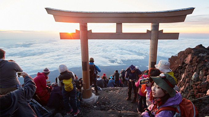 Hikers stop at this gateway as the sun rises on Mount Fuji. | Photo by Rob Andrew