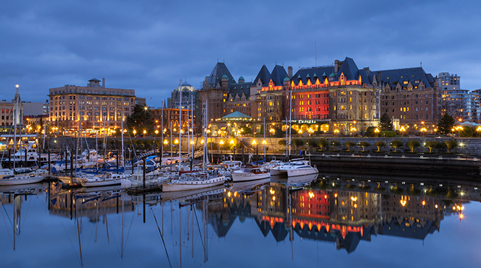 The lights along Victoria's Inner Harbour and the Fairmont Empress hotel in the distance illuminate the night. | Photo by D'Arcy Leck/Alamy Stock Photo 
