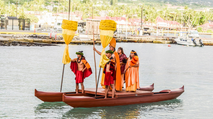 Island Breeze Lūʻau performers enter on a watercraft