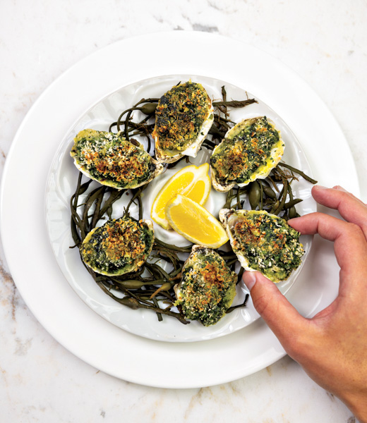 Oysters arranged on a plate with lemon wedges at The Bedford by Martha Stewart