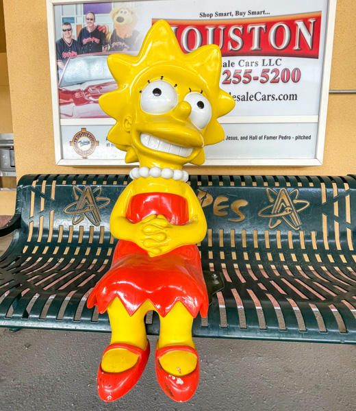 Statue of Lisa Simpson sitting on a bench at Isotopes Park.