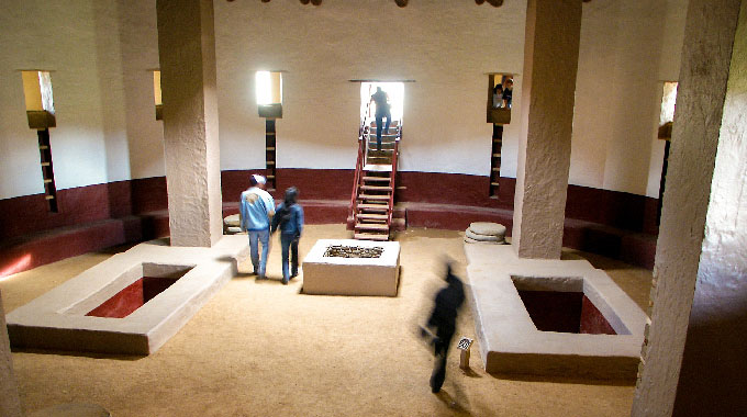 Visitors inside the Aztec Great House at the Aztec Ruins National Monument.