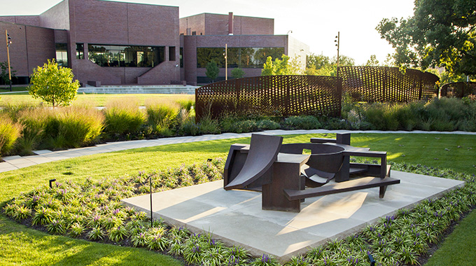 Artist Isaac Witkin’s brushed steel “Yantra,” in the foreground, is one of 13 fascinating sculptures that surround the Wichita Art Museum. | Photo courtesy Wichita Art Museum