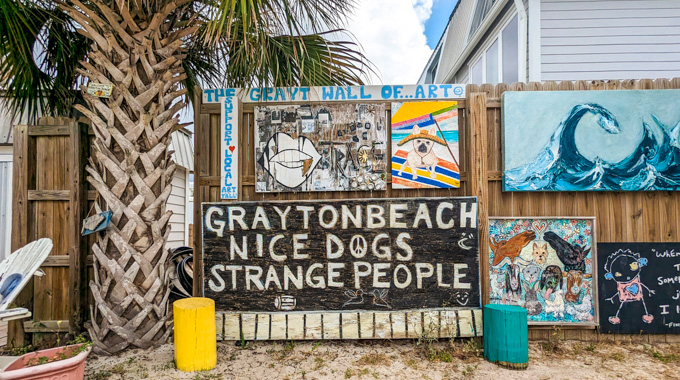 Grayton Beach sign reading "Grayton Beach, nice dogs, strange people."