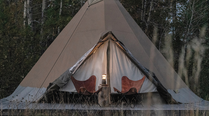A pair of camp chairs in front of a tepee at Bodhi Farms.